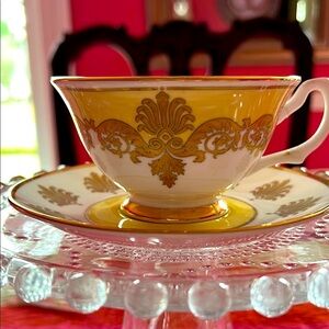 Elegant Gold and Cream Teacup and Saucer from Buckingham Palace